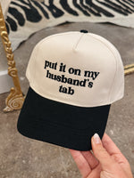 Husbands Tab Trucker Hat in Black